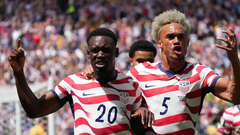 FILE -- United States' Folarin Balogun (20) and Antonee Robinson (5) celebrate after...