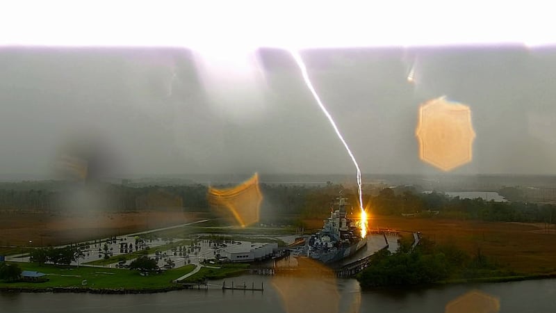 A photo capturing the moment lightning strikes the Battleship NC during a storm on Aug. 16, 2026.