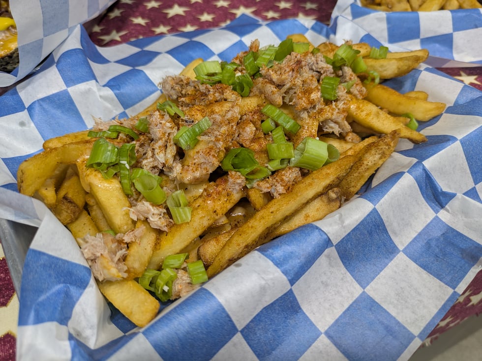 A pile of fries, smothered in cheese, crab meat and Old Bay seasoning...these alone are worth...