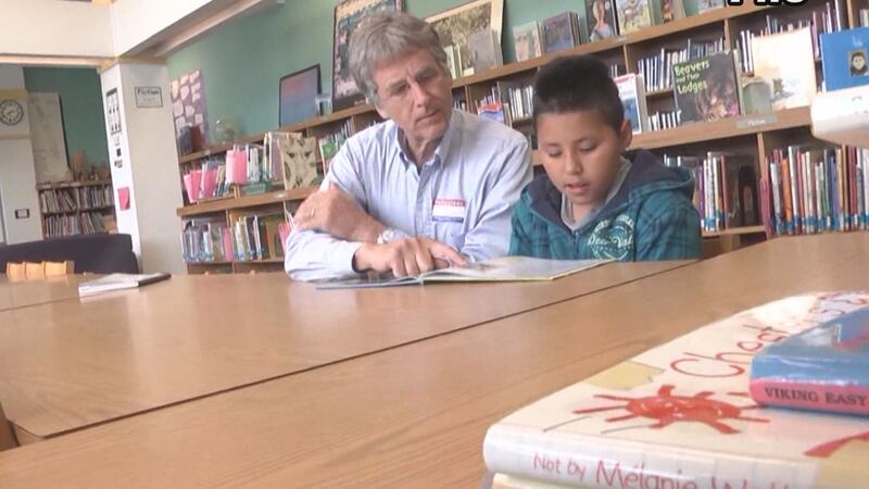 volunteer mentors student as part of Friends in Schools Helping program