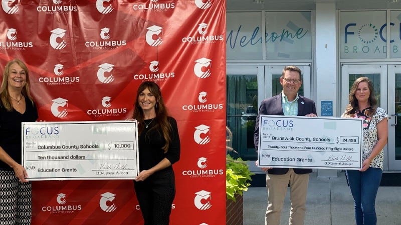 Checks presented to educators by FOCUS Broadband