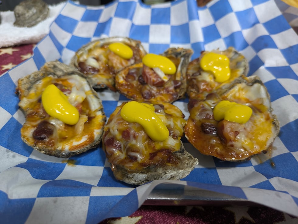 An oyster...Coney-style? It doesn't make sense, but these oysters are topped with chili,...