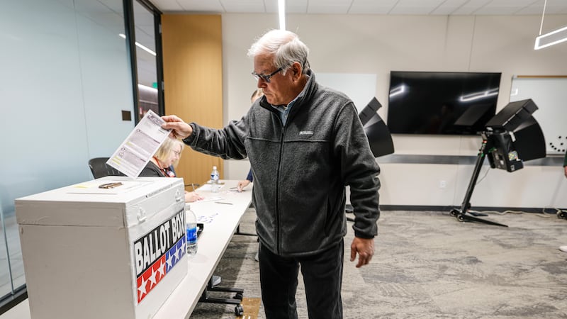 A voter casts a ballot during early voting in Waukesha, Wis., Tuesday, March 18, 2025. (AP...