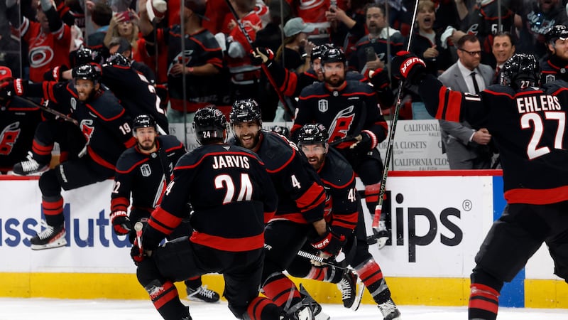 Carolina Hurricanes' Seth Jarvis (24) celebrates after his winning goal with teammates Shayne...