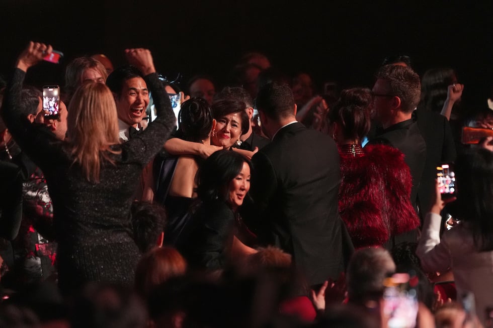The team from KPop Demon Hunters react in the audience to winning the award for best song...