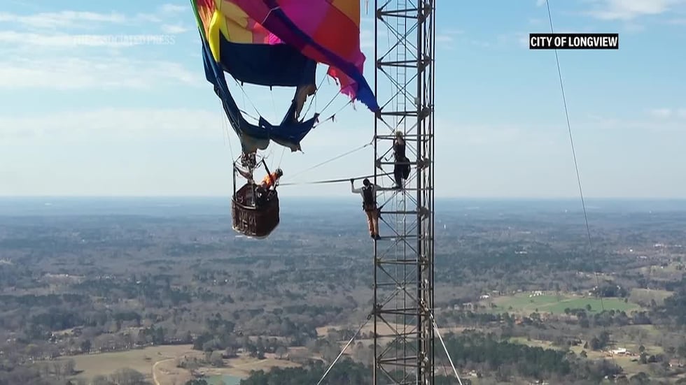 Crews rescued two people stranded hundreds of feet in the air after a hot-air balloon became...
