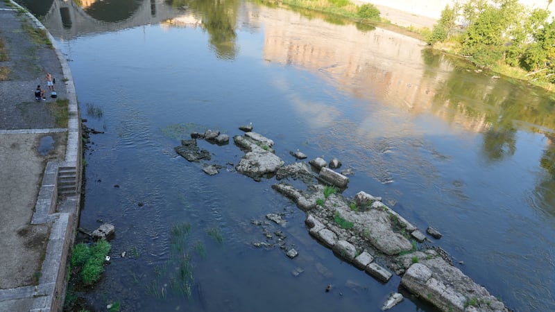 The ruins of the ancient Roman Neronian bridge, emerge from the riverbed of the Tiber river...