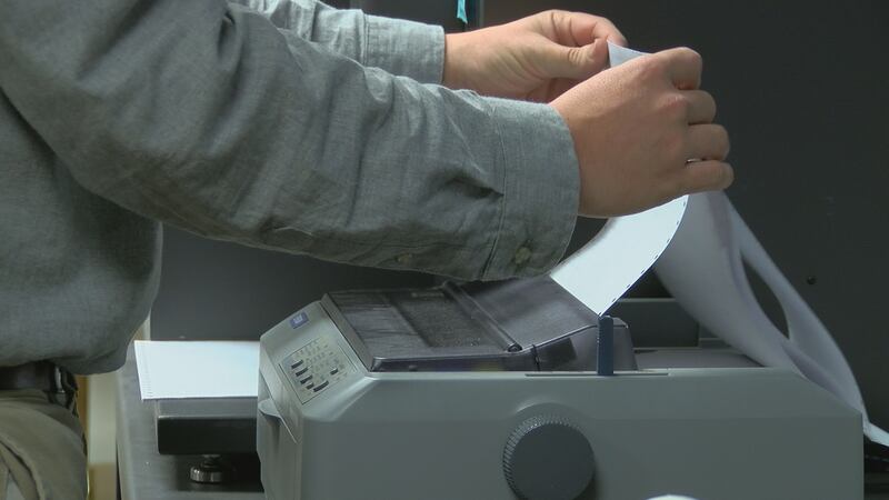 Absentee ballot results are printed at the New Hanover County Board of Elections (Source: WECT).